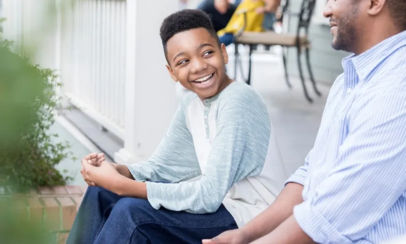 Boy talking to dad about staying home alone