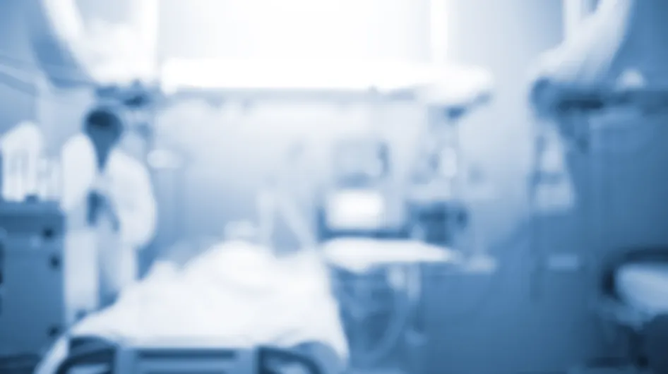 An artistically blurred photo of an empty hospital bed in an intensive care unit
