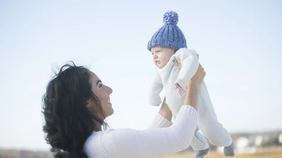 A mom holds a baby named Frank up in the air