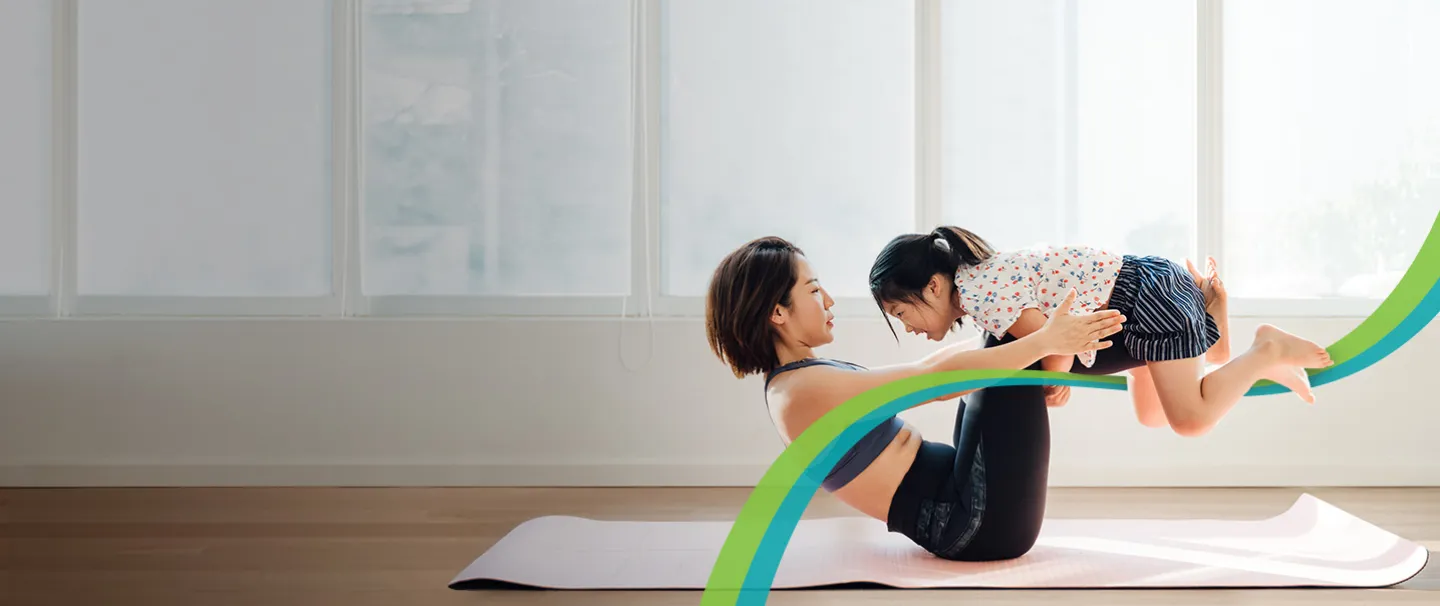 Woman doing yoga with daughter
