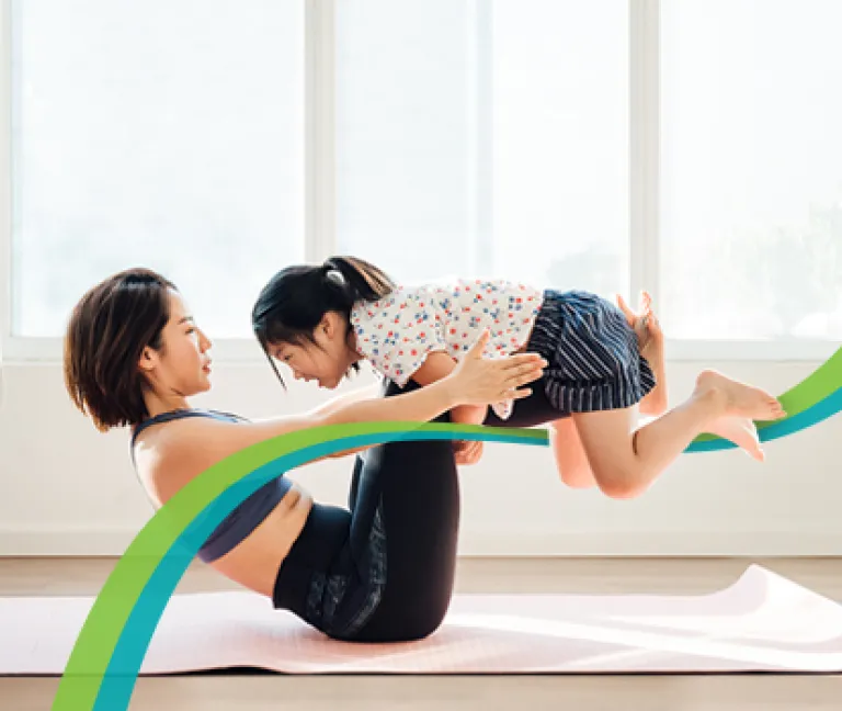 Woman doing yoga with daughter