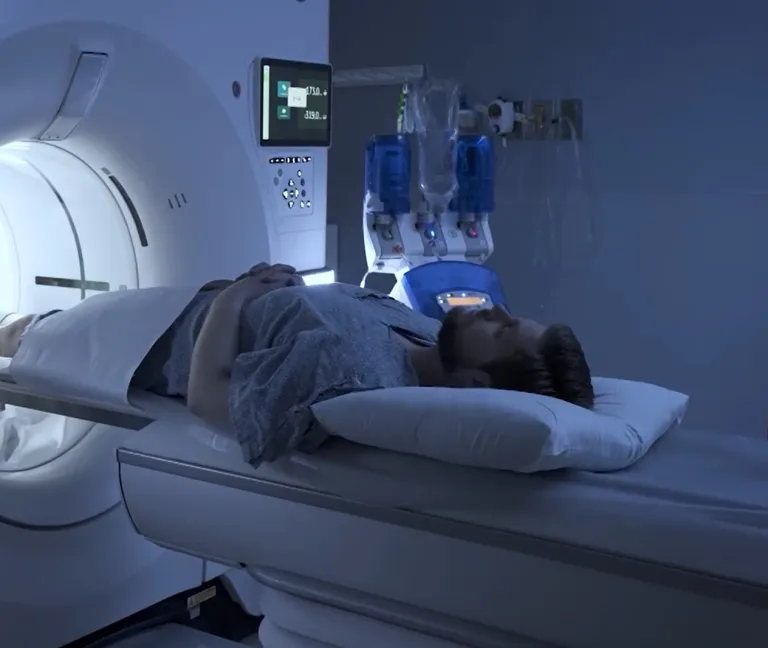 A man lays on a MRI bed as he prepares for a scan at South Shore Health