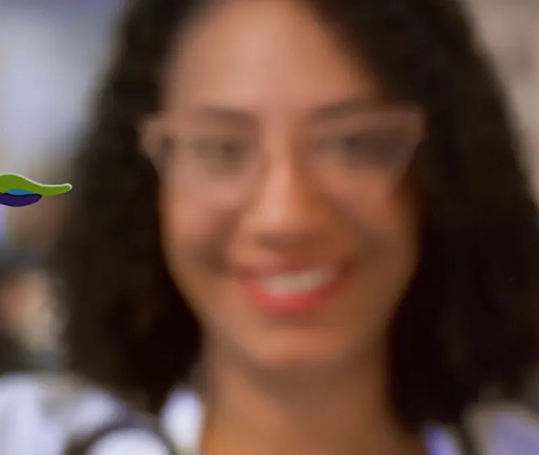 Monique Nugent, MD of South Shore Health holds up a small wooden version of the South Shore Health gulls logo