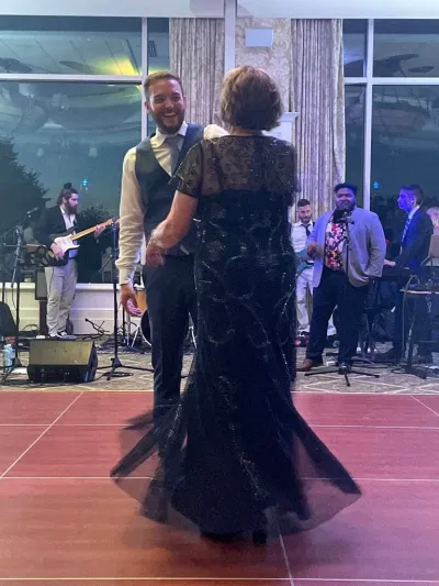 A groom dances with his mother at his wedding