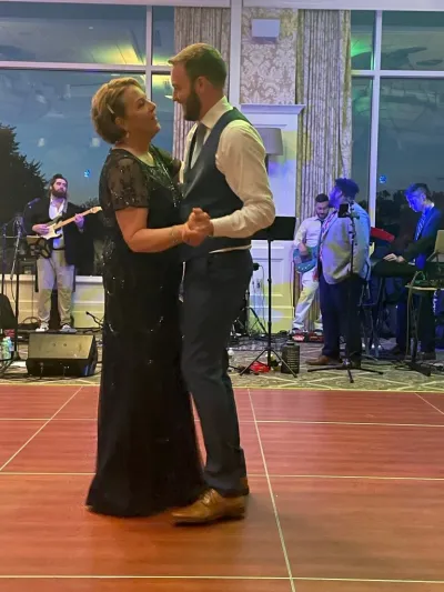 Woman dancing with her son at a wedding