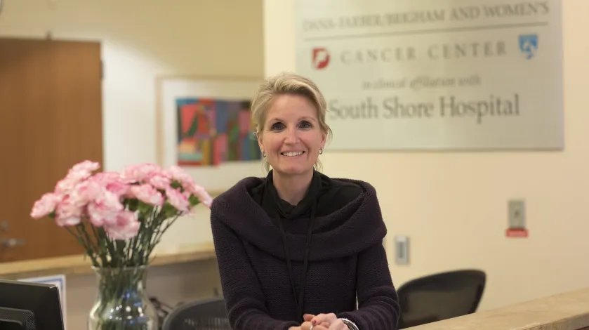 A receptionist in the lobby of the Dana-Farber/Brigham and Women's Cancer Center at South Shore Hospital