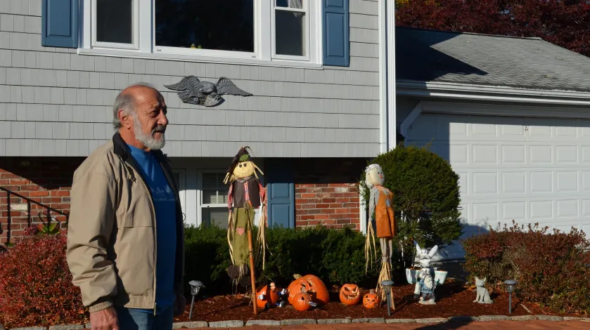 Richard Lalond stands on his front lawn with his house windows in the background.