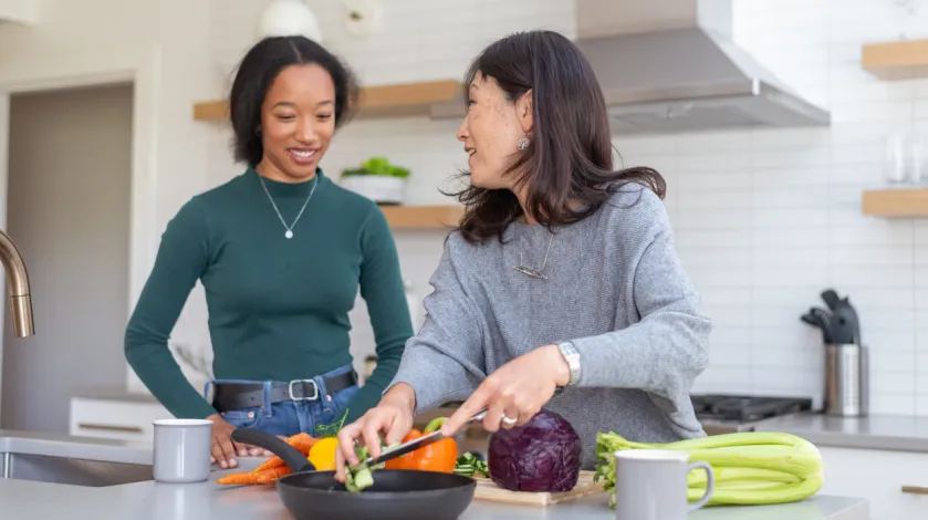 Two women cook a healthy meal at home