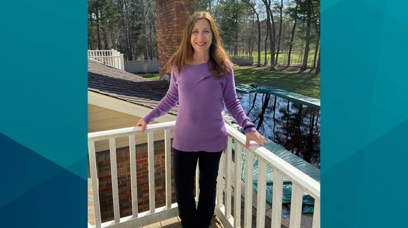 Patient Jo-Ann stands on her deck for a photo. Jo-Ann shared her story of her same-day joint replacement procedure at South Shore Health.