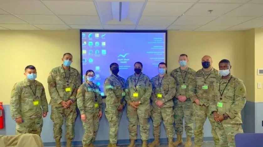 Members of the Massachusetts National Guard pose for a photo at South Shore Hospital, where they've been deployed to assist with operations.