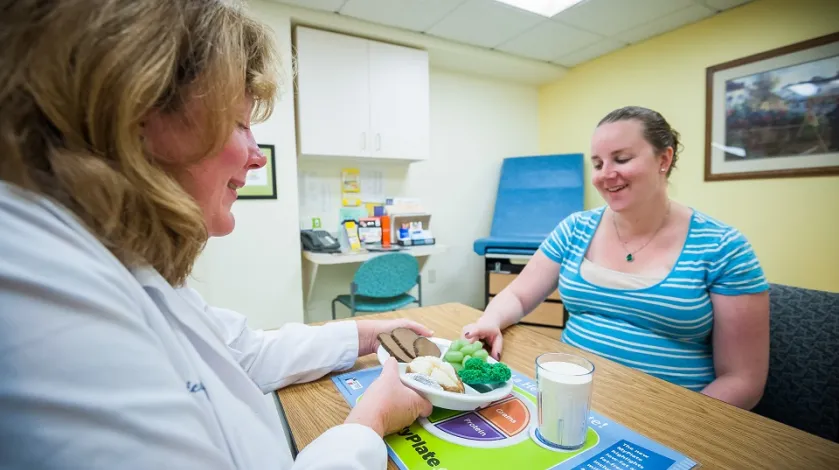 Diabetes educator works with a female diabetes patient