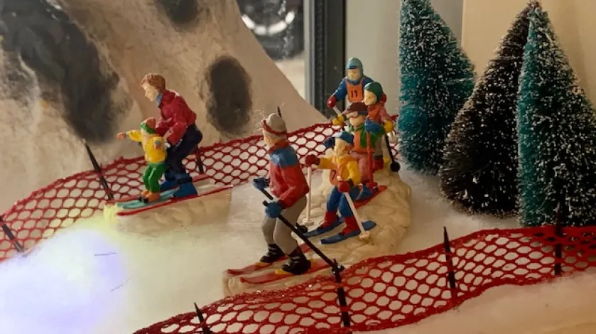 Skier figurines on a ski slope