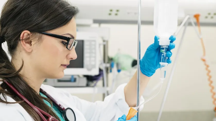 Female anesthesia doctor with IV in hospital room