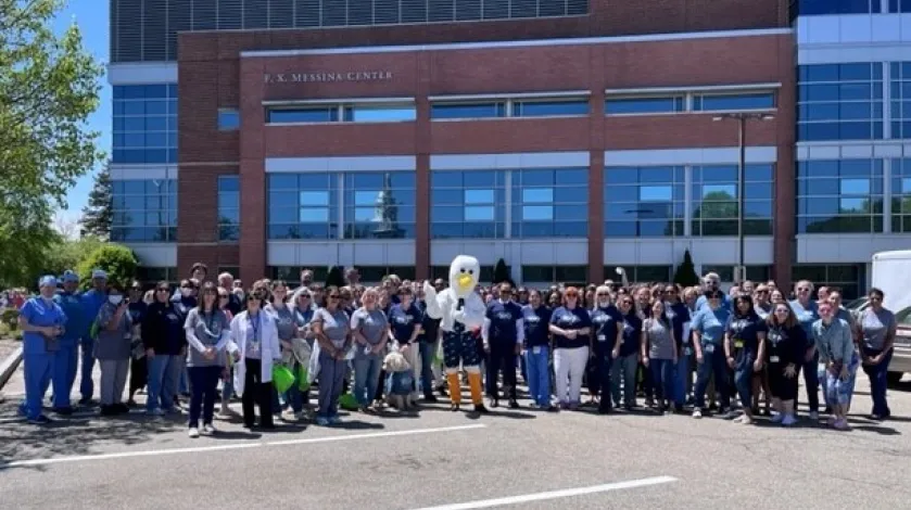 A large group of South Shore Health colleagues in front of South Shore Hospital
