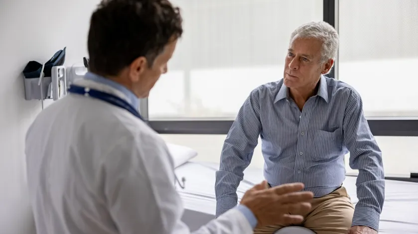 A doctor consults with a older male patient