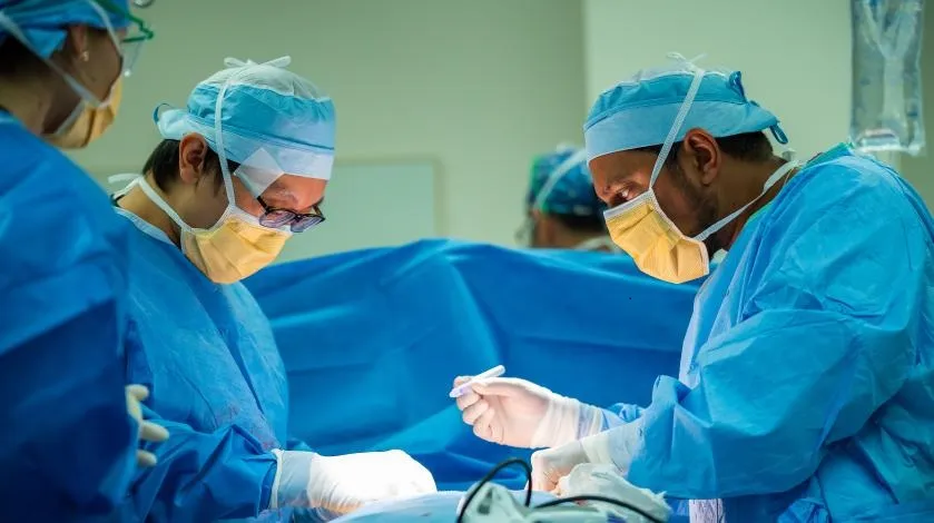 A surgeon performs bariatric surgery on a patient