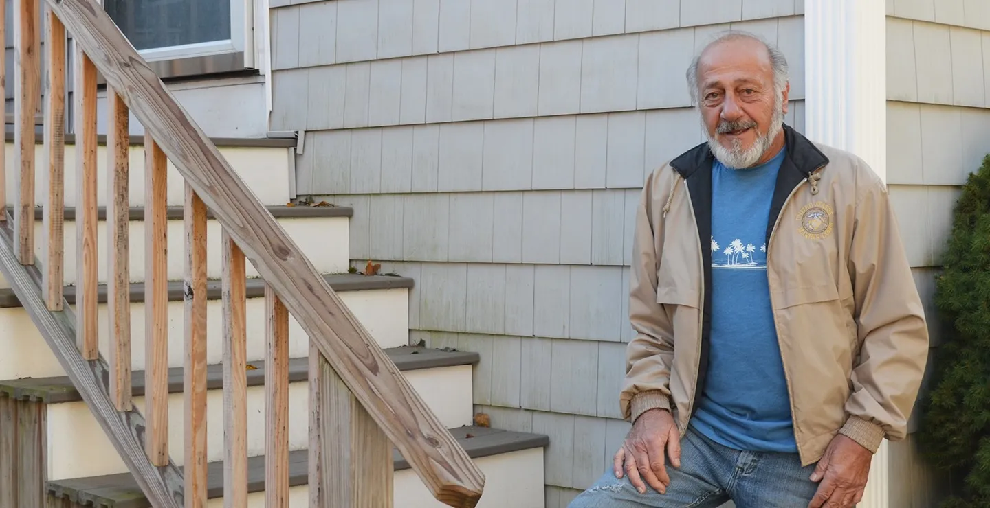 Richard Lalond of Weymouth stands for a portrait in his backyard