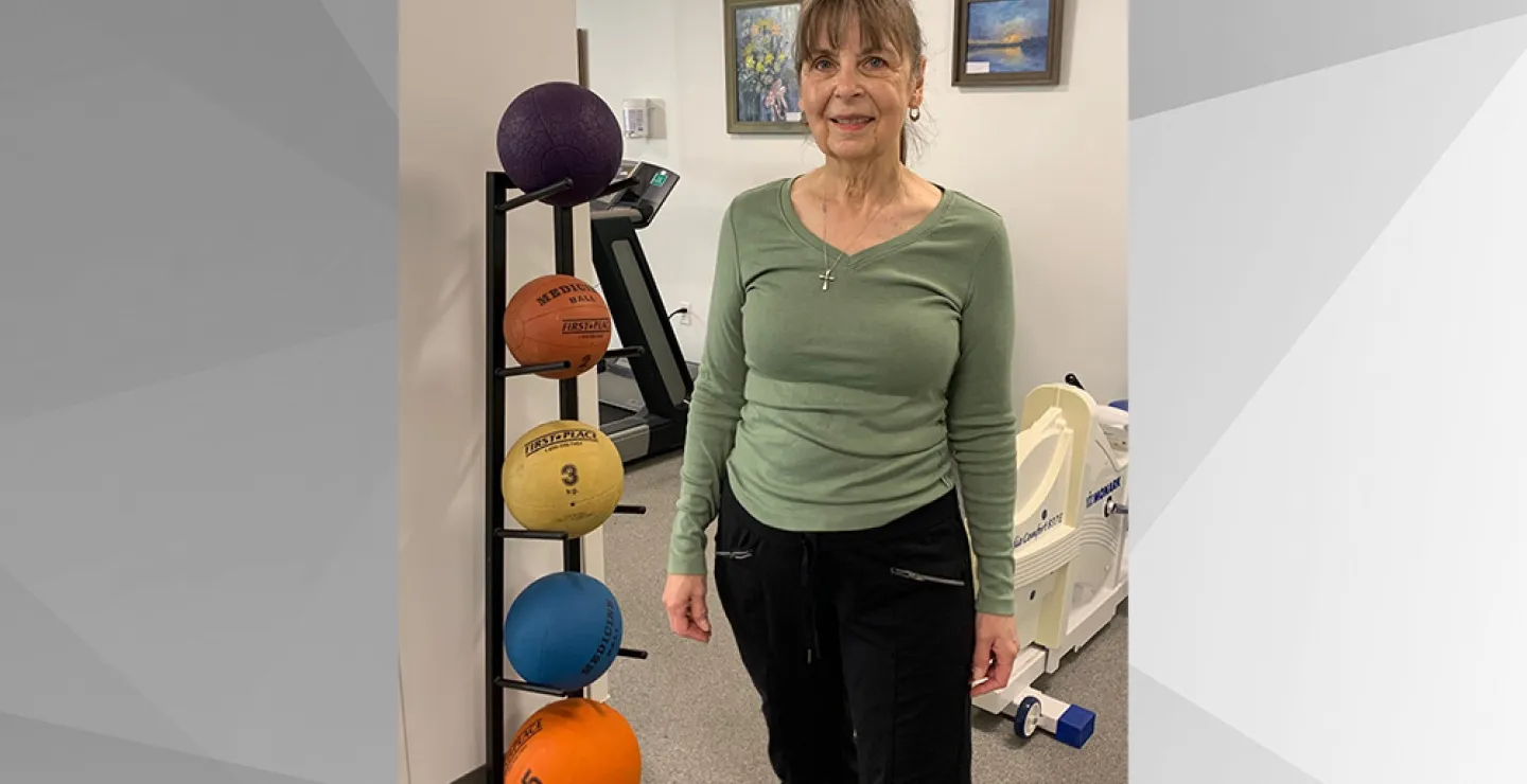Ruth of Weymouth poses in front of medicine balls and a spinning back prior to her community exercise class at South Shore Health