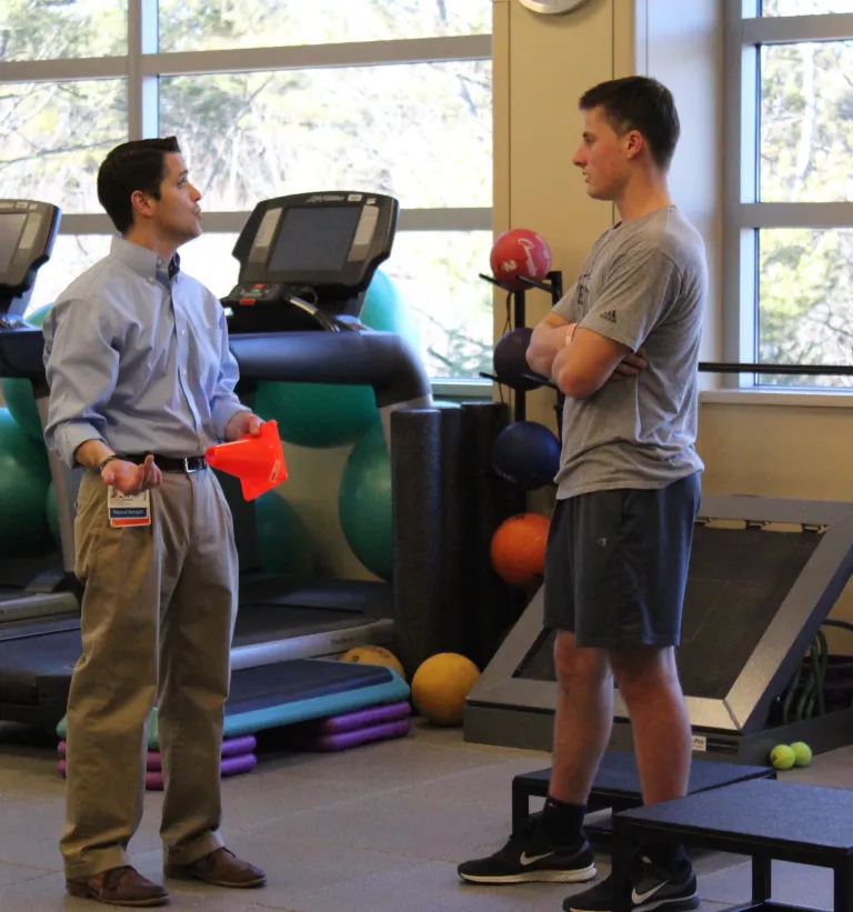 Patient Nick Hall takes a break from therapy to talk with PT Dan Murray at South Shore Health