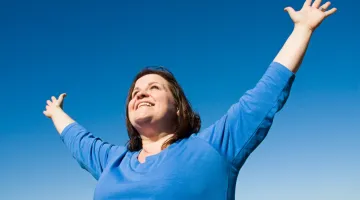 Woman holding arms up in joy