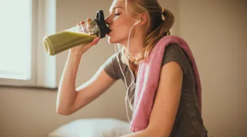 Woman drinking smoothie post-workout