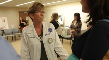 Nannette Landry, Certified Nurse Midwife, talks to a mom