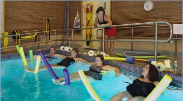 Moms-to-be exercising in a pool