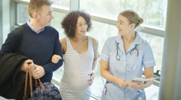 Expecting parents carrying a hospital bag