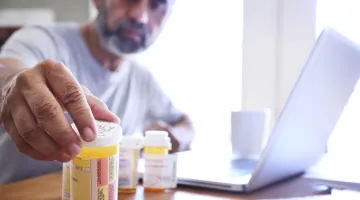 Man looking at medications
