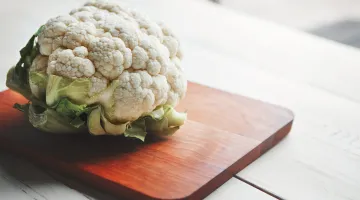 Head of cauliflower on a wooden cutting board