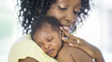Baby sleeping on Mom's shoulder