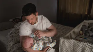 Tired parents getting baby to sleep