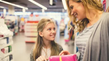A mother and daughter talk about sanitary products in a store