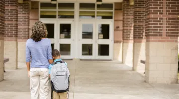 mother and son looking at school doors