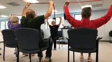A small group exercising with a personal trainer