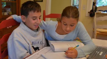 The author's two children learning at home