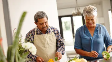 An older couple cooks a nutritious meal together