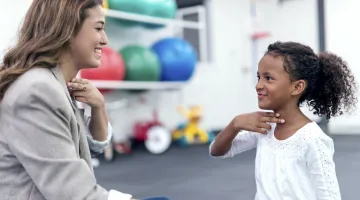 Child having a speech therapy appointment with a speech language pathologist