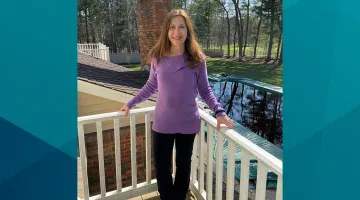 Patient Jo-Ann stands on her deck for a photo. Jo-Ann shared her story of her same-day joint replacement procedure at South Shore Health.