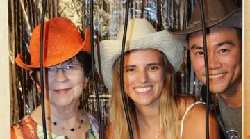 Attendees pose for a photo at a Western-themed jail backdrop at South Shore Health's 2021 Kickin' Up Country fundraiser.