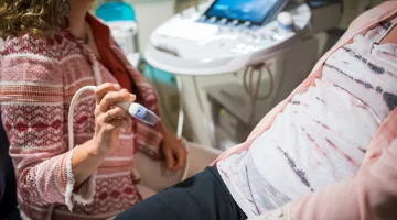 A South Shore Health provider prepares to do an ultrasound on a pregnant patient.