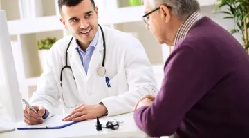 Doctor talking to older male patient