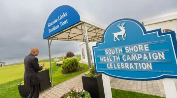 A sign at Granite Links in Quincy reads "South Shore Health Campaign Celebration" at the May 2022 celebration of the end of the Mission Critical campaign.