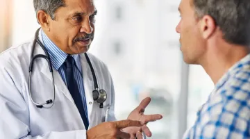 Doctor consulting with a middle aged male patient