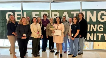 Eight members of South Shore Health's CPDS Team pose for a group photo at South Shore Hospital