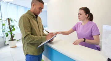 A male patient checks in at patient registration