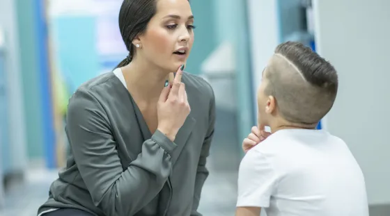 A speech therapist working with a pediatric patients