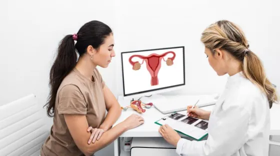 A gynecologist speaks with a young female patient